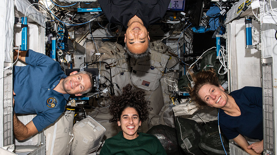 Four Expedition 70 crew members pose for a portrait inside their crew quarters. Clockwise from bottom are, astronauts Jasmin Moghbeli, Andreas Mogensen, Satoshi Furukawa, and Loral O'Hara.