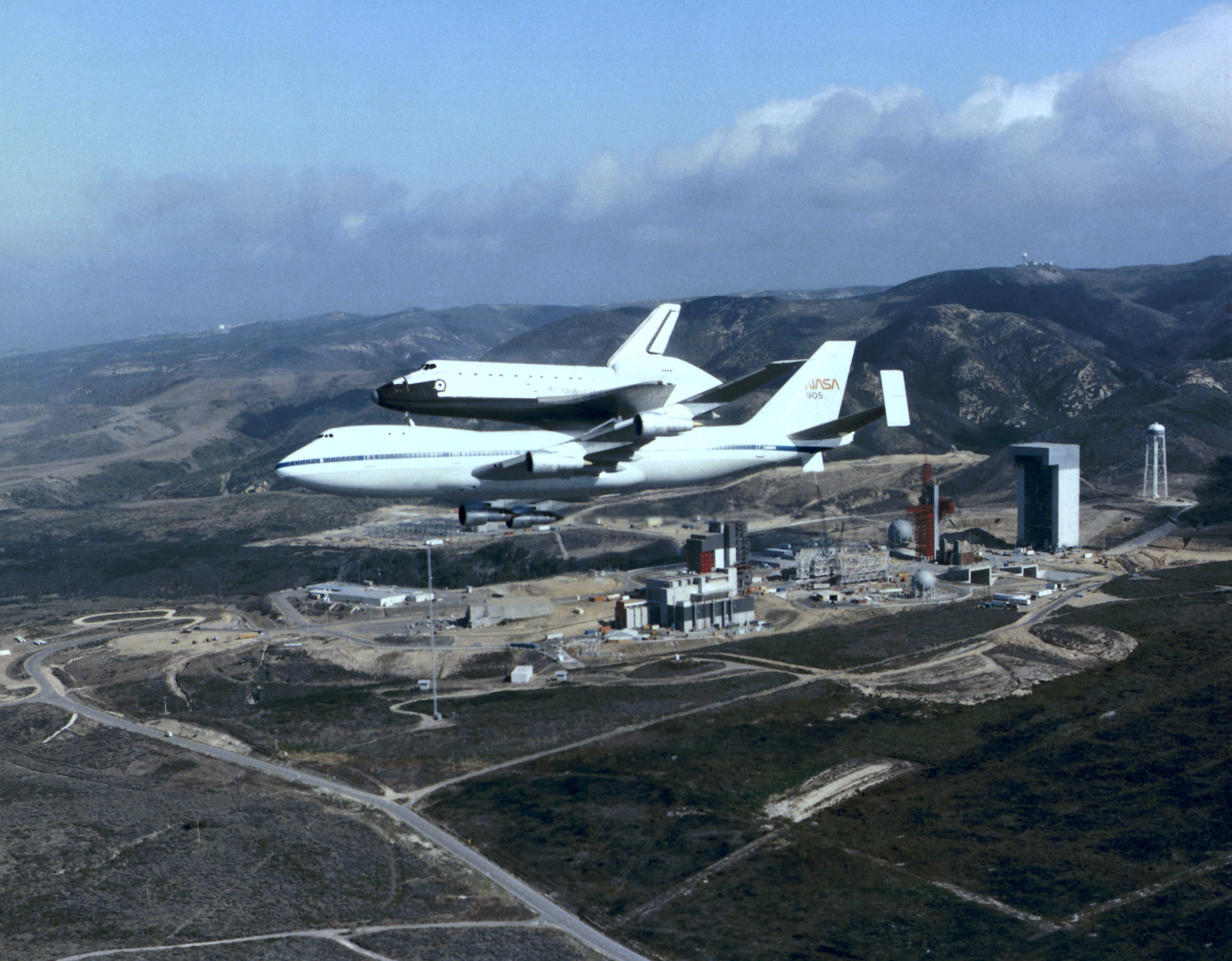 Space shuttle Discovery atop its Shuttle Carrier Aircraft (SCA) flies over Vandenberg Air Force Base
