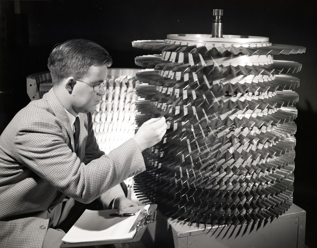 Man pointing to multi-stage compressor.