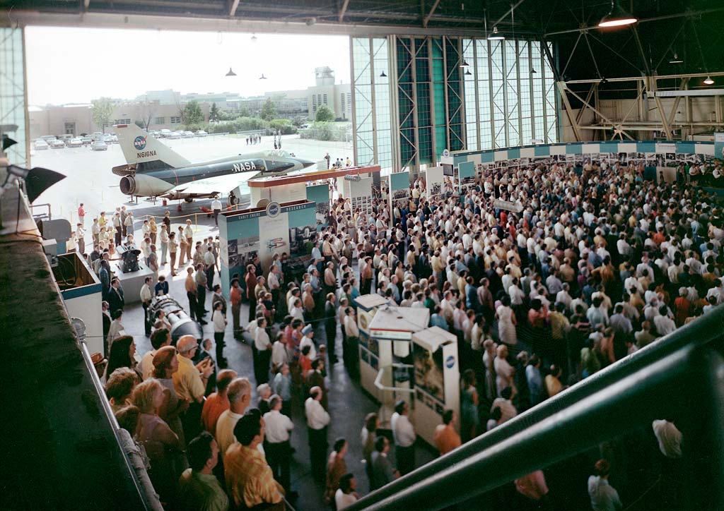 Crowd inside hangar.