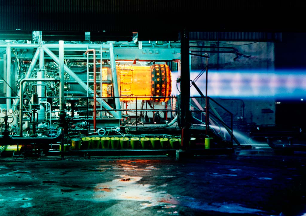 Engine firing horizontally at night.