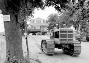 Tractor pulling house.
