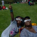 Two people viewing an eclipse wearing special glasses
