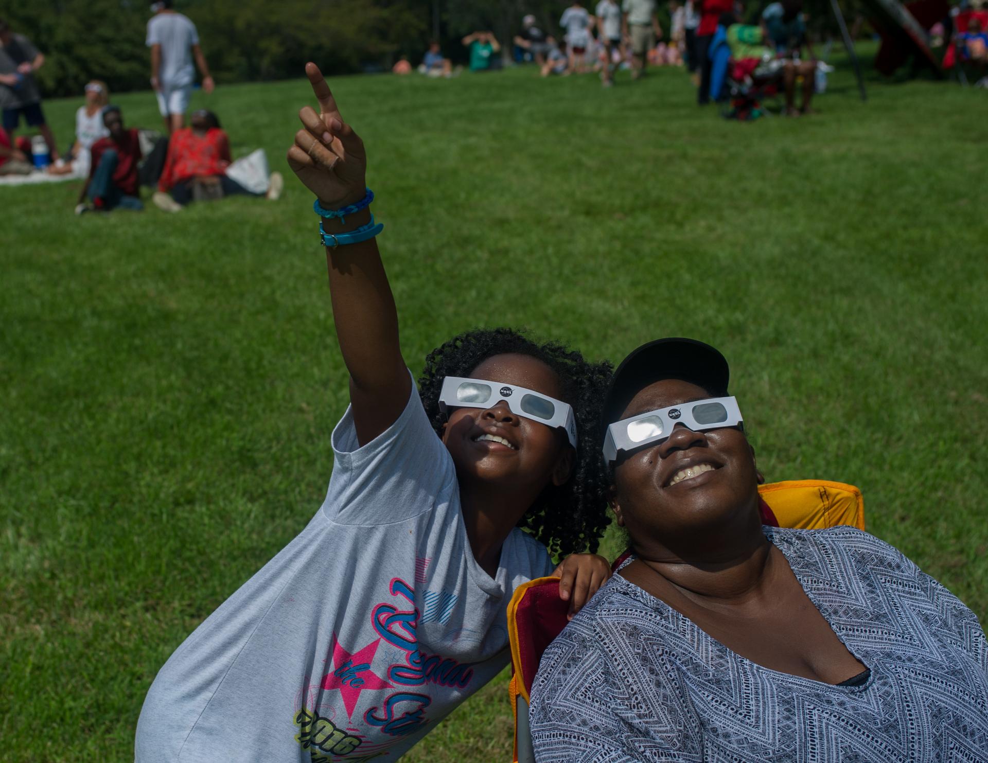 Two people viewing an eclipse wearing special glasses