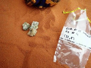 Rock samples collected during a simulated Marswalk are pictured atop orange-brown sand in the sandbox where the crews complete EVAs, or Extravehicular Activities. 