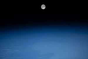 The waning gibbous Moon is pictured above Earth from the International Space Station as it soared into an orbital nighttime 260 miles above the Atlantic Ocean near the northeast coast of South America.
