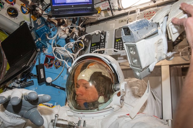 ESA (European Space Agency) astronaut and Expedition 70 Commander Andreas Mogensen is pictured trying on his spacesuit and testing its components aboard the International Space Station's Quest airlock in preparation for an upcoming spacewalk.