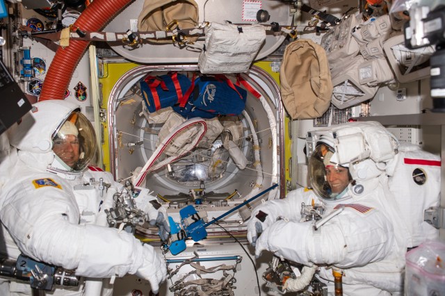 Astronauts Andreas Mogensen from ESA (European Space Agency) and Loral O'Hara from NASA try on their spacesuits and test the suits' components aboard the International Space Station's Quest airlock in preparation for an upcoming spacewalk.