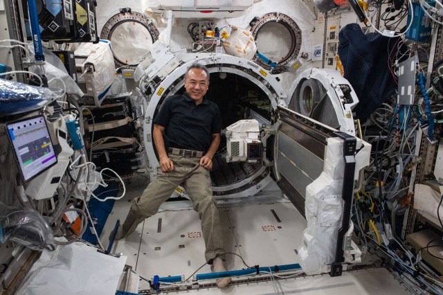 JAXA (Japan Aerospace Exploration Agency) astronaut and Expedition 70 Flight Engineer Satoshi Furukawa loads camera and light hardware into the Kibo laboratory module's airlock that will be installed outside the International Space Station.