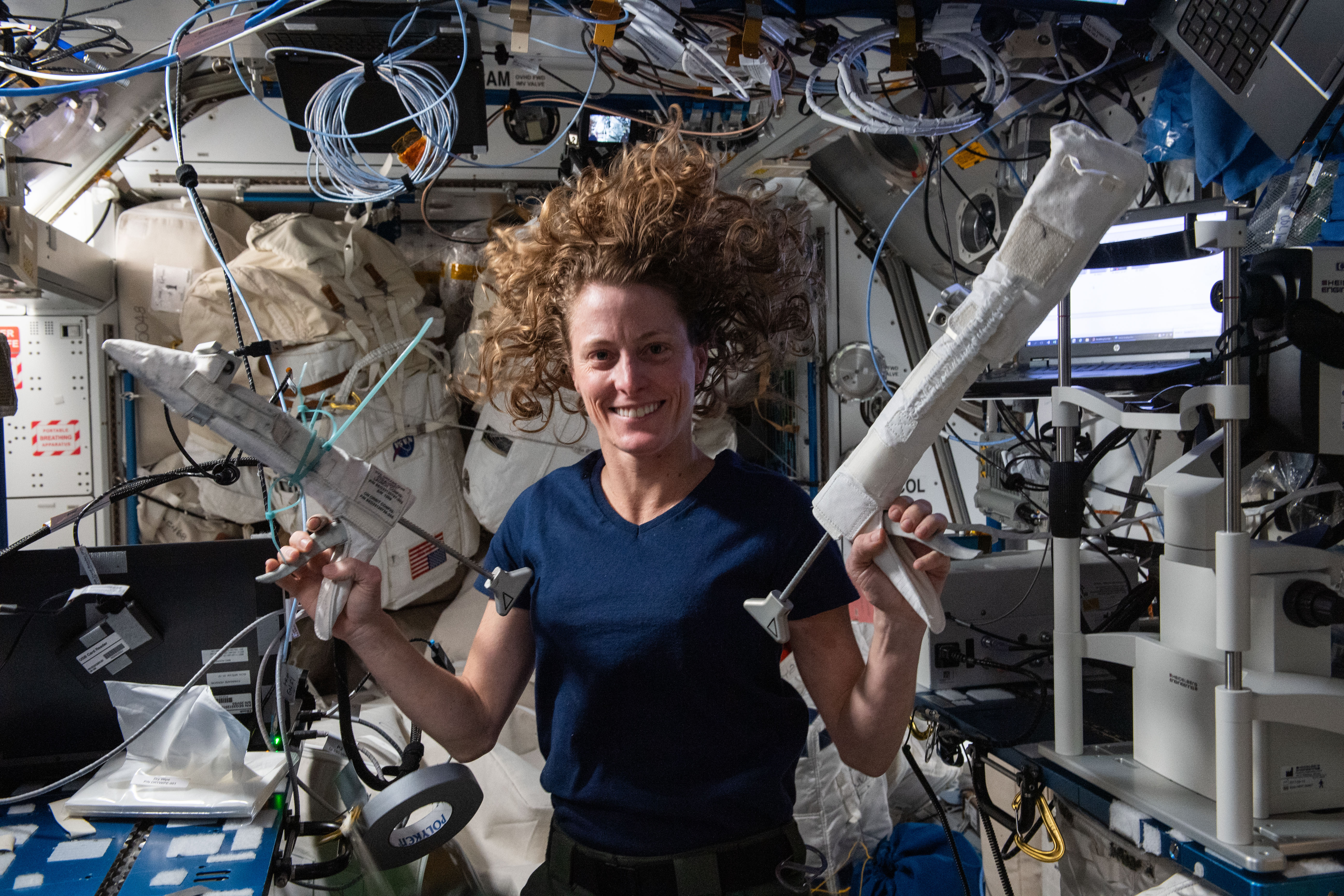 NASA astronaut and Expedition 70 Flight Engineer Loral O'Hara shows off tools she will use during a spacewalk to swab surfaces on the International Space Station and collect potential microbe samples for analysis.