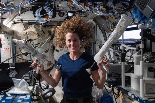 NASA astronaut and Expedition 70 Flight Engineer Loral O'Hara shows off grease guns that will be used during an upcoming spacewalk at the International Space Station.