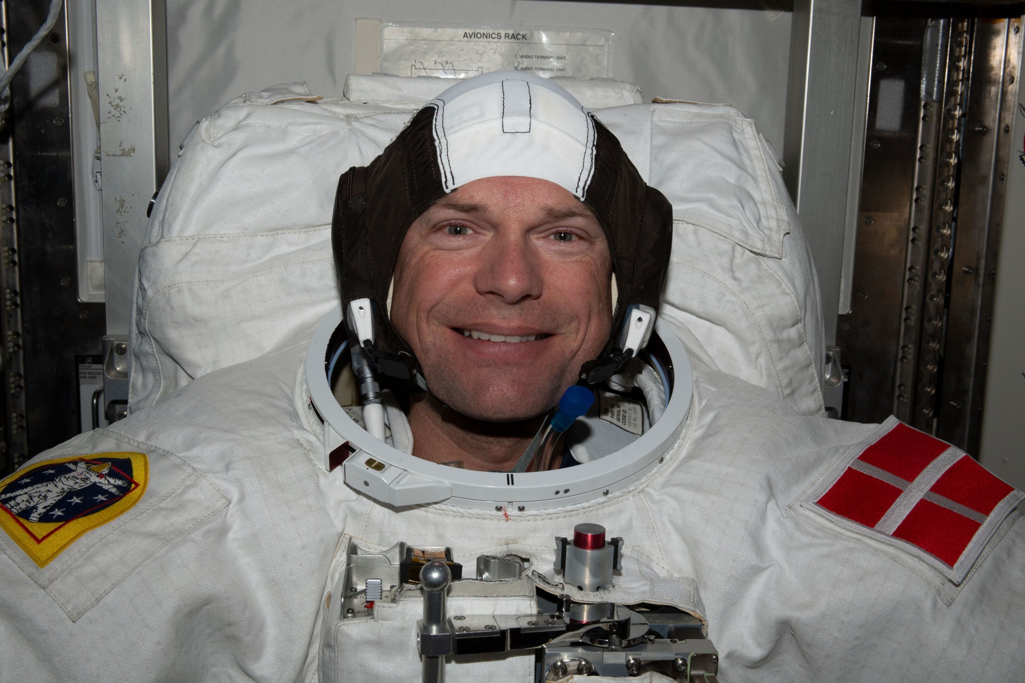 ESA (European Space Agency) astronaut and Expedition 70 Commander Andreas Mogensen is pictured trying on his spacesuit and testing its components aboard the International Space Station's Quest airlock in preparation for an upcoming spacewalk.