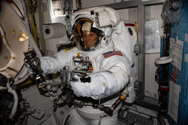 NASA astronaut and Expedition 70 Flight Engineer Loral O'Hara is pictured trying on her spacesuit and testing its components aboard the International Space Station's Quest airlock in preparation for an upcoming spacewalk.