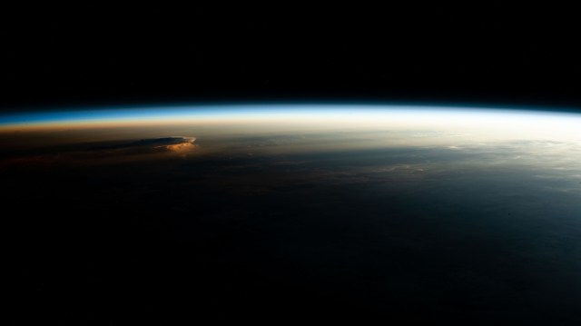 An orbital sunrise casts elongated cloud shadows in this photograph from the International Space Station as it orbited 260 miles above the Peru-Ecuador border in South America.