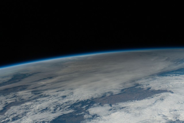 The Moon passes in front of the sun casting its shadow, or umbra, and darkening a portion of the Earth's surface during the annular solar eclipse. The International Space Station was soaring 260 miles above the U.S.-Canadian border as this picture was taken pointing southward toward Texas.