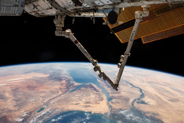 The Canadarm2 robotic arm extends from the International Space Station as it orbited 261 miles above Turkey. Below, the Sinai Peninsula, the Red Sea, and the Nile River Delta are pictured leading toward the Mediterranean Sea at bottom.