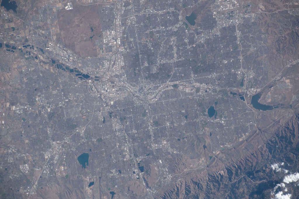 Denver, Colorado, split by the South Platte River and next to the Rocky Mountains, is pictured from the International Space Station as it orbited 262 miles above the Centennial State.