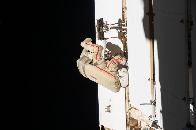 Expedition 70 Flight Engineer Oleg Kononenko from Roscosmos is pictured during a spacewalk to inspect a backup radiator, deploy a nanosatellite, and install communications hardware on the International Space Station's Nauka science module.
