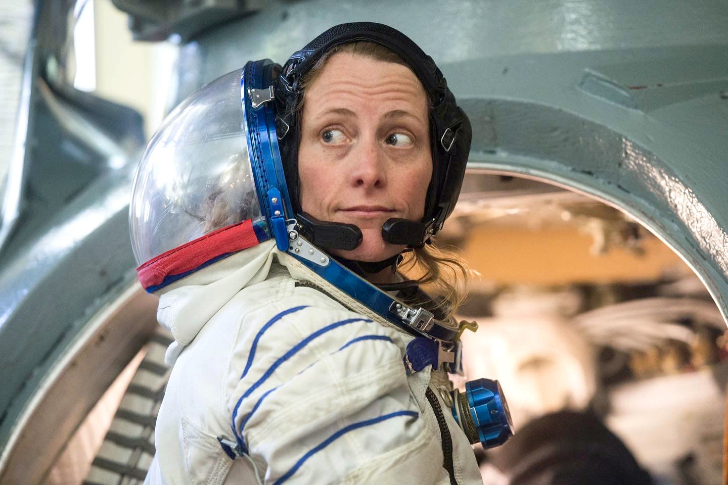 NASA astronaut Loral O'Hara prepares to enter a Soyuz spacecraft simulator in her Sokol launch and entry suit for preflight training before beginning her mission to the International Space Station