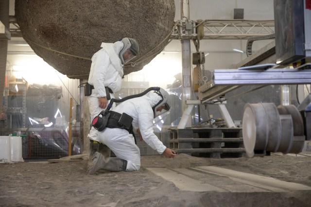 A team at NASA’s Kennedy Space Center in Florida tests small- and medium-sized bucket drums July 16, 2021, in the Granular Mechanics and Regolith Operations Lab’s “big bin” during prototype development for the pilot excavator.