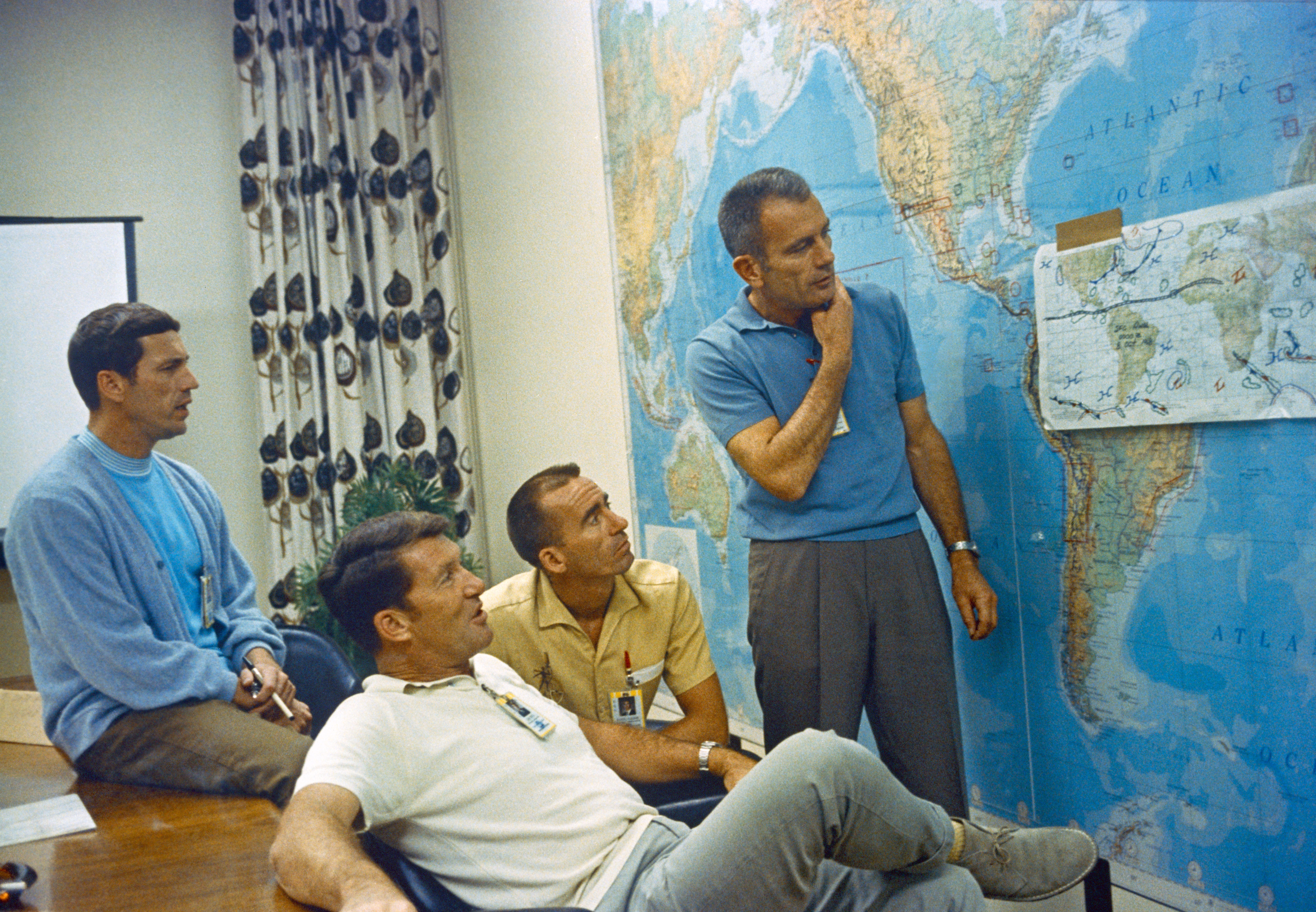 Apollo 7 astronauts Donn F. Eisele,Walter M. Schirra, and R. Walter Cunningham review flight trajectories with Director of Flight Crew Operations Donald K. “Deke” Slayton shortly before launch