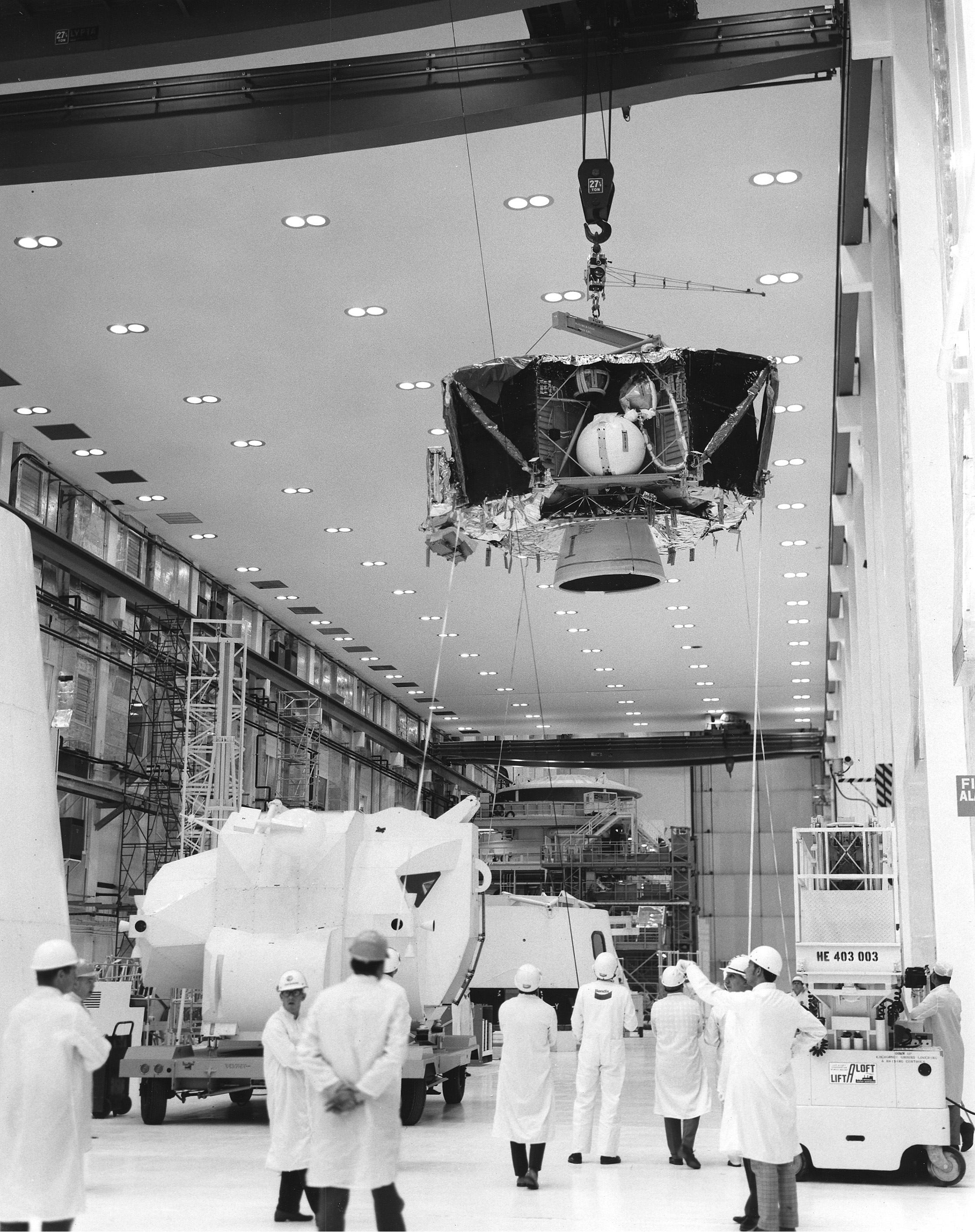 Workers in the Manned Spacecraft Operations Building (MSOB) at NASA’s Kennedy Space Center in Florida uncrate the Apollo 10 Lunar Module (LM) descent stage shortly after its arrival
