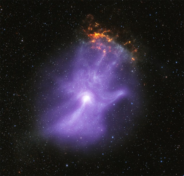 This release features a composite image of a pulsar wind nebula, which strongly resembles a ghostly purple hand with sparkling fingertips. A pulsar is a highly magnetized collapsed star that rotates and creates jets of matter flowing away from its poles. These jets, along with intense winds of particles, form pulsar wind nebulae. Here, the pulsar wind nebula known as MSH 15-52 resembles a hazy purple cloud set against a black, starry backdrop. Both NASA's Chandra X-ray Observatory and the Imaging X-ray Polarimetry Explorer (IXPE) have observed MSH 15-52. Their observations revealed that the shape of this pulsar wind nebula strongly resembles a human hand, including five fingers, a palm and wrist. The bright white spot near the base of the palm is the pulsar itself. The three longest fingertips of the hand-shape point toward our upper right, or 1:00 on a clock face. There, a small, mottled, orange and yellow cloud appears to sparkle or glow like embers. This orange cloud is part of the remains of the supernova explosion that created the pulsar. The backdrop of stars was captured in infrared light.