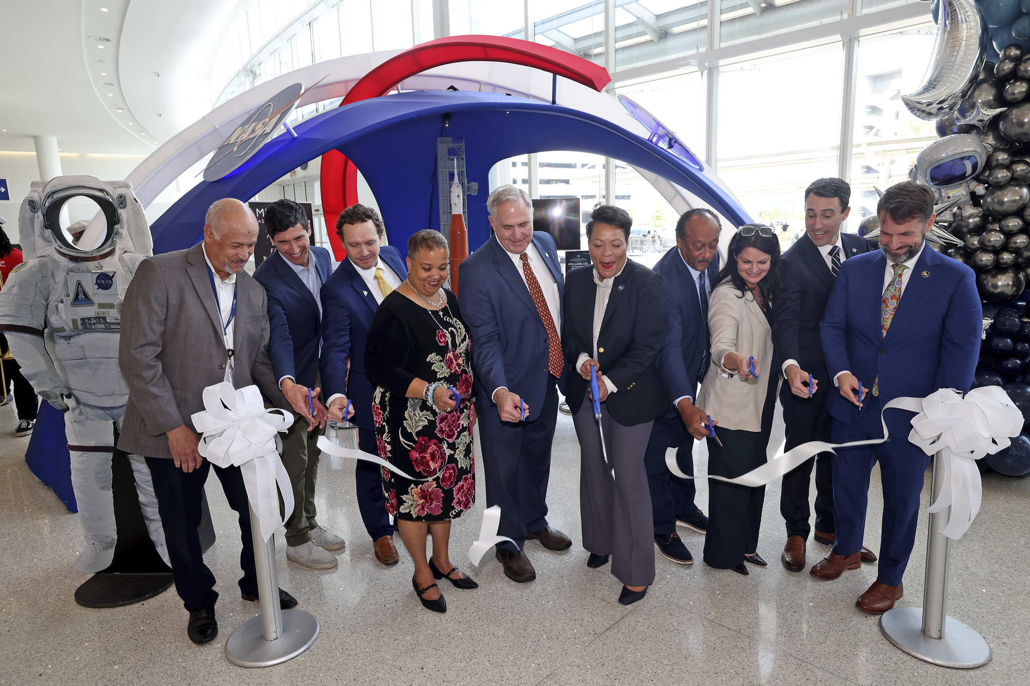 From left, New Orleans Airport Director Kevin Dolliole, New Orleans Director of Economic Development Jeff Schwartz, Space Launch System Stages Element Office Resident Management Office Manager Gregg Eldridge, Congressman Carter’s District Director Demetric Mercadel, Michoud Director Lonnie Dutreix, New Orleans Mayor LaToya Cantrell, Judge Michael Bagneris, New Orleans & Co. Executive Vice-President Alice Glenn, New Orleans Business Alliance Interim President Louis David, and GNO Inc. Senior Vice-President of Business Development Josh Fleig cut the ribbon at the NASA educational display ribbon-cutting ceremony at Louis Armstrong International Airport in New Orleans.