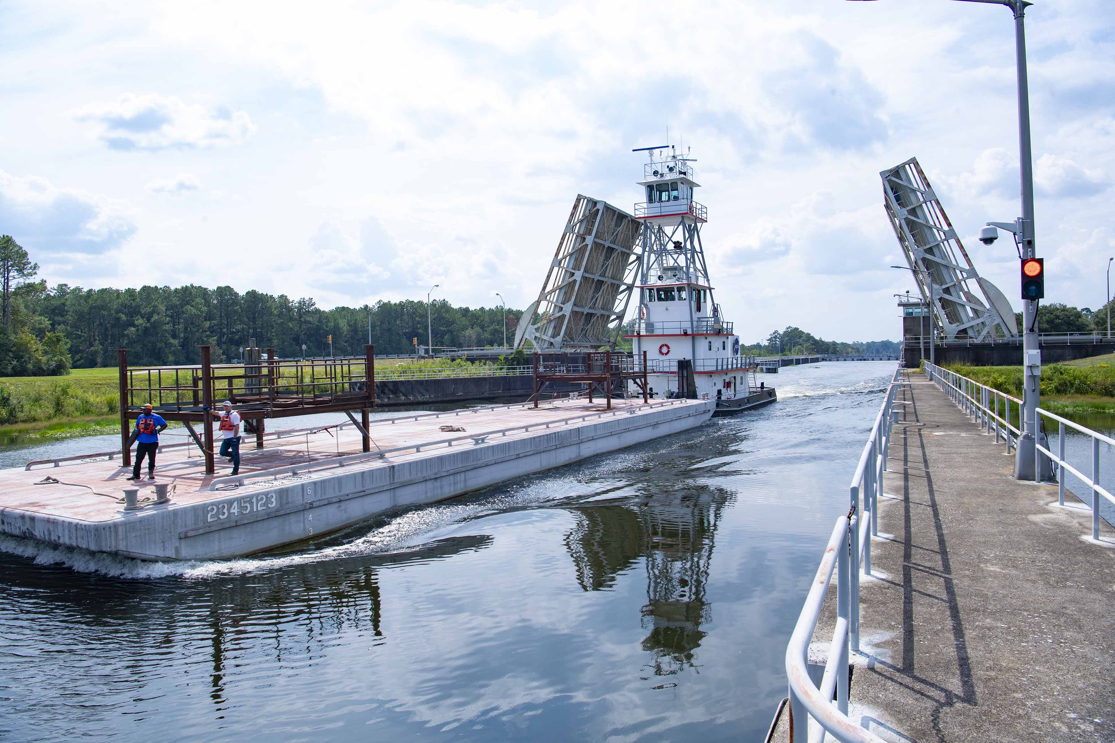 A pair of umbilical support structures arrive by barge at NASA’s Stennis Space