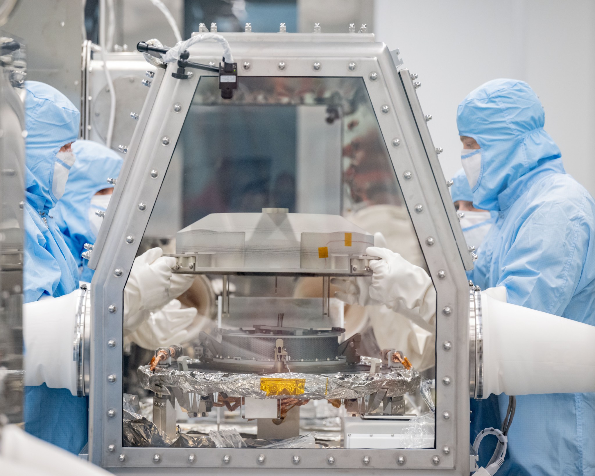 Photographic coverage of OSIRIS REx Asteroid Sample Return lid opening at Building 31 Astromaterials Curation Facility.