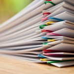 stack of papers on a desk 
