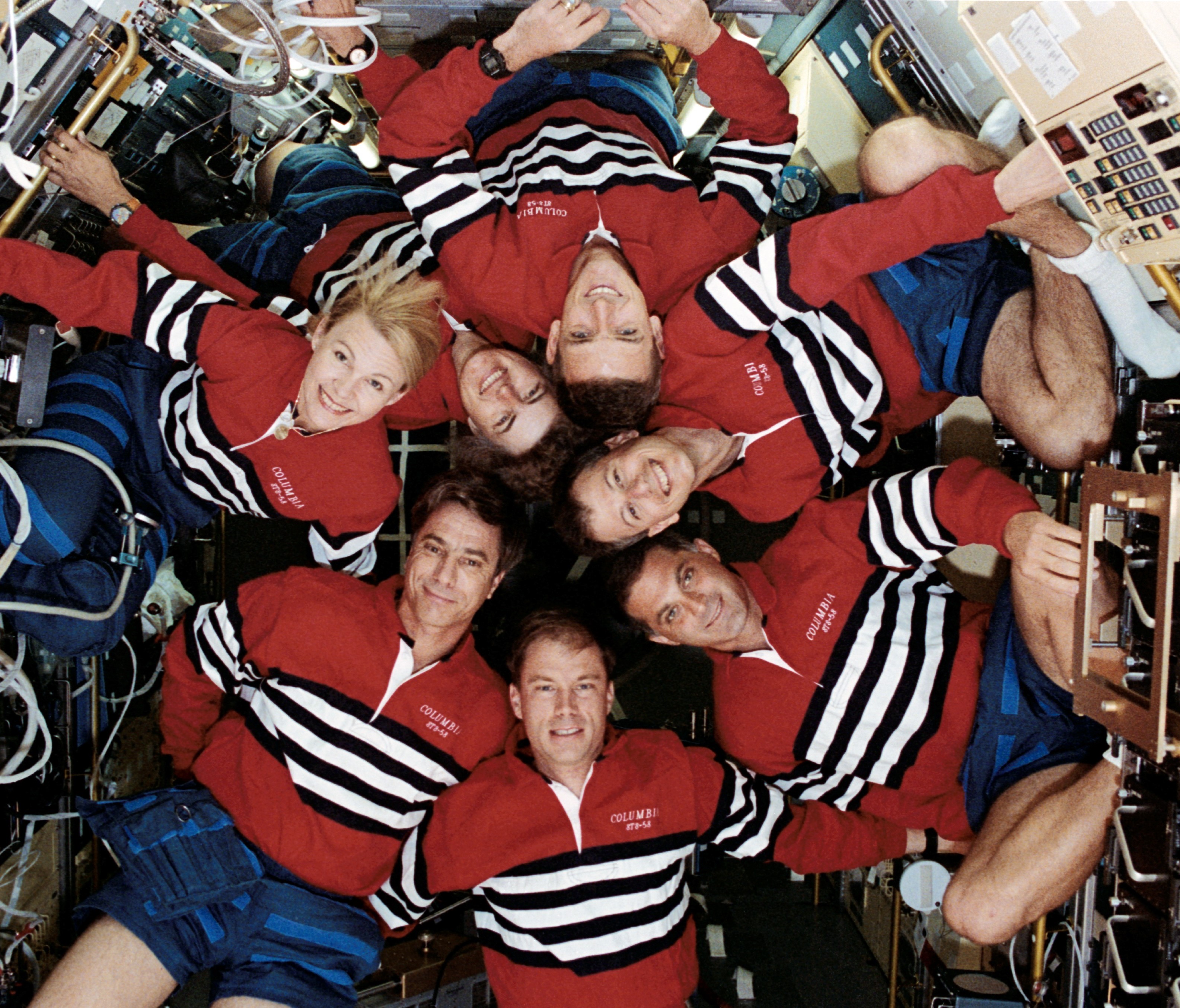 STS-58 astronauts William A. McArthur, top, Martin J. Fettman, David A. Wolf, Richard A. Searfoss, John E. Blaha, M. Rhea Seddon, and Shannon M. Lucid inside the Spacelab module