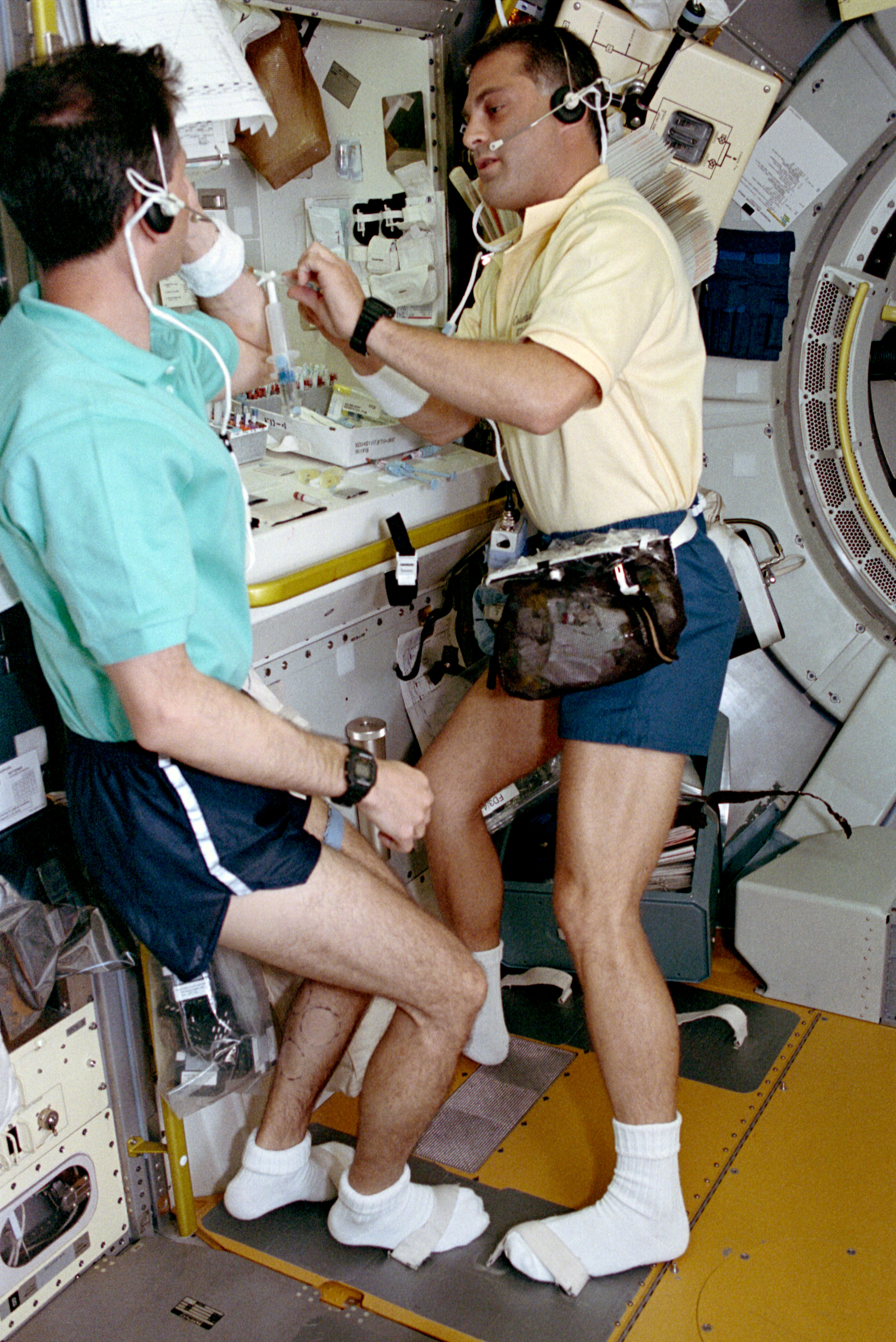 Dr. David A. Wolf draws a blood sample from Dr. Martin J. Fettman as part of a regulatory physiology experiment