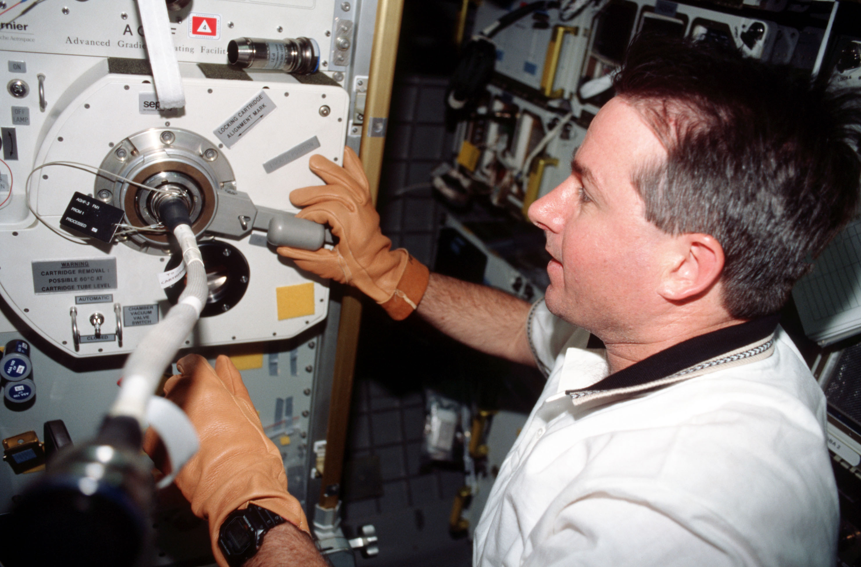 Stephen K. Robinson processes a sample in the Advanced Gradient Heating Facility (AGHF)