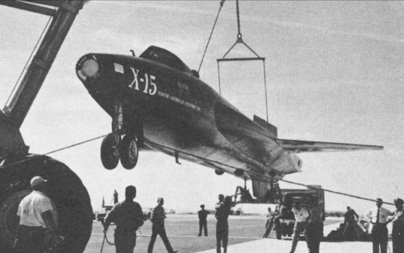 Workers at Edwards Air Force Base in California lift the first X-15 off its delivery truck
