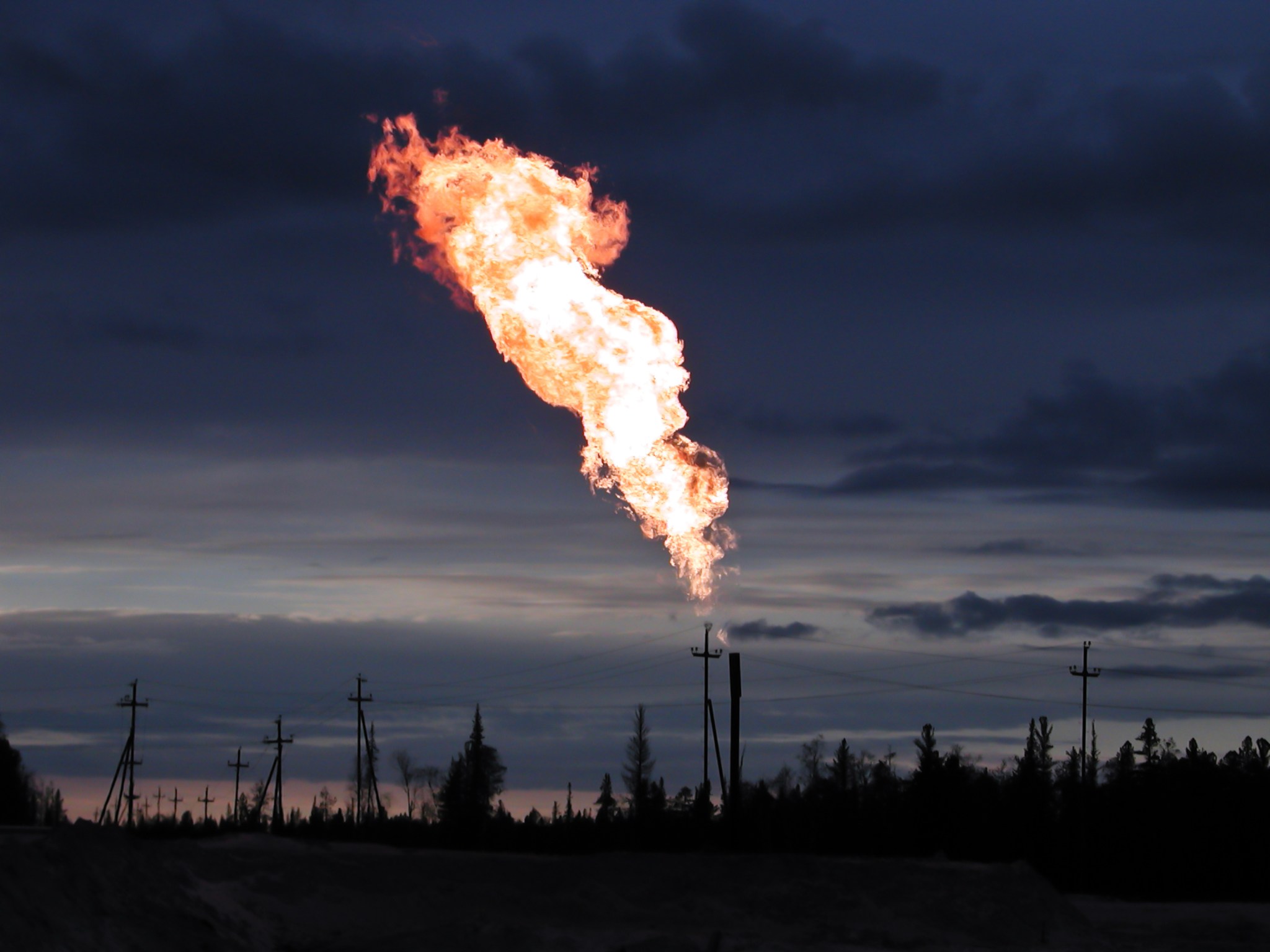 Picture of burning oil gas flare outdoors