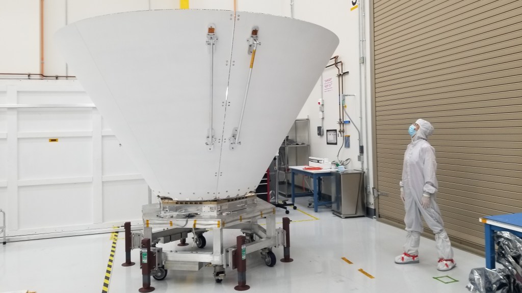 Sara Susca, deputy payload manager and payload systems engineer for NASA’s SPHEREx mission, looks up at one of the spacecraft’s photon shields