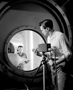 Man aims camera into wind tunnel test section