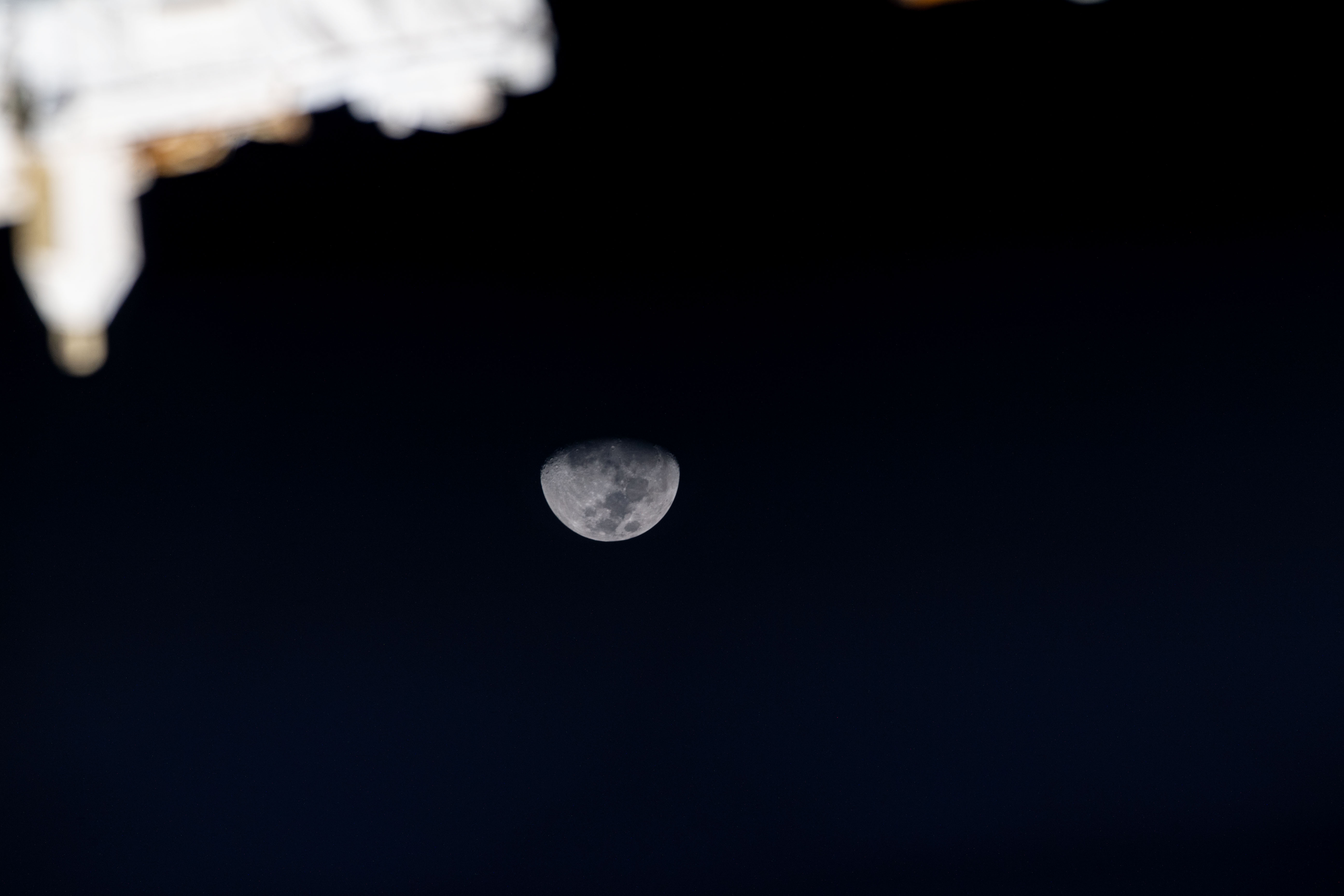 iss070e008966 (Oct. 24, 2023) -- The Moon reaches third quarter phase surrounded by the black of space as the International Space Station orbited 260 miles above the Indian Ocean.