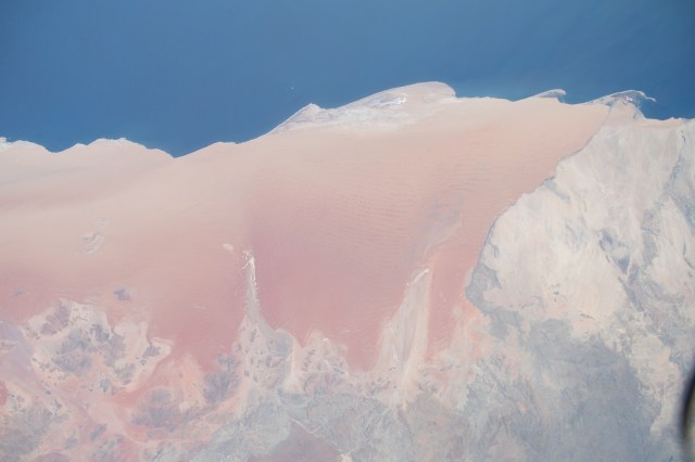 iss070e015047 (Oct. 28, 2023) -- Sand meets the Atlantic Ocean in the Namib Desert as the International Space Station orbited 260 miles above southwestern Africa. Sculpted by winds, the desert is home to some of the tallest dunes on the planet.