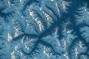 iss070e028152 (Nov. 20, 2023) -- What looks like the spreading of roots is a view of the Hindu Kush mountain range from the International Space Station as it soared 260 miles above. The base of the mountains are shadowed by the Sun reflecting off peaks. Stretching through Central and South Asia, the range extends 500 miles (~800 kilometers) across.