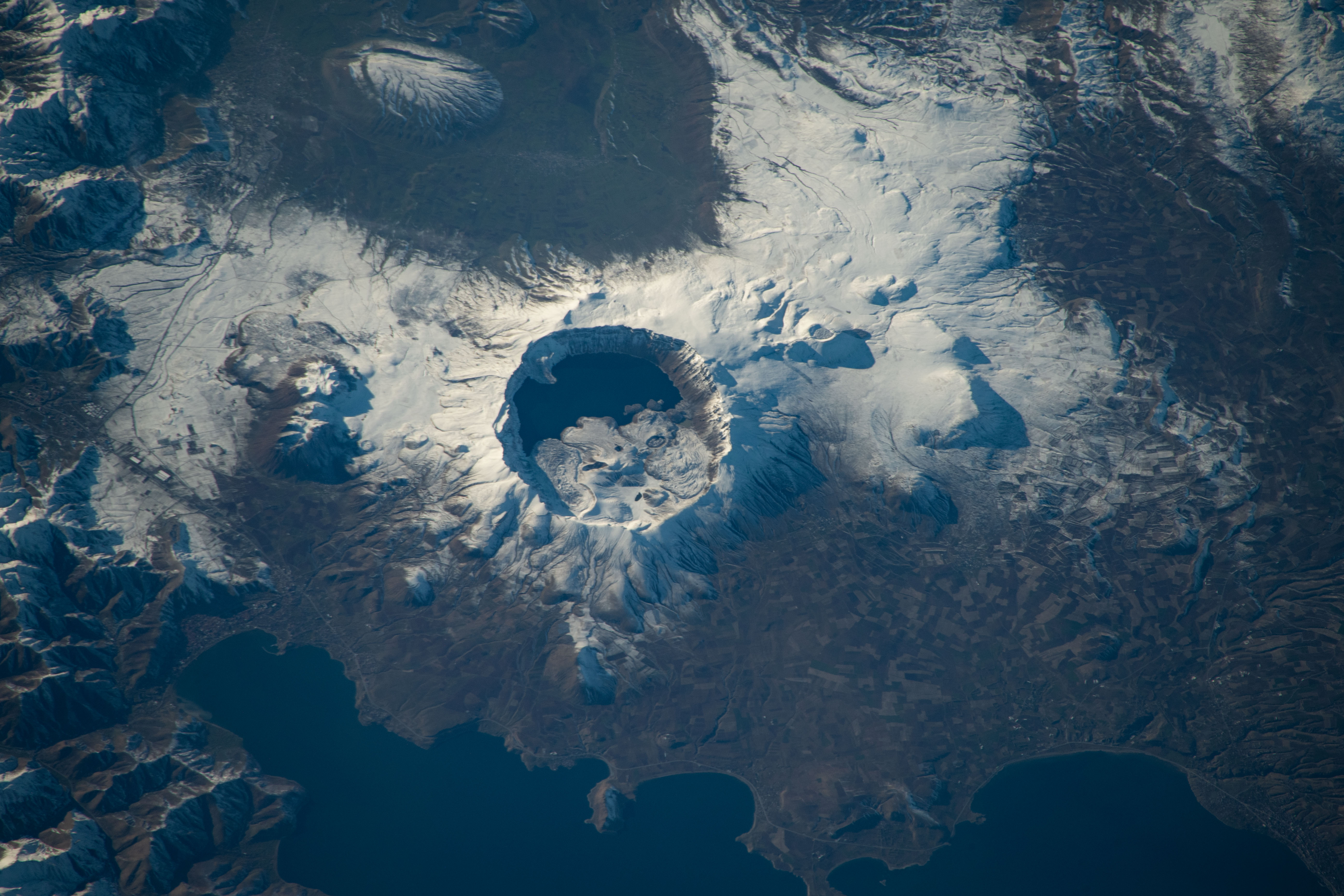 iss070e029717 (Nov. 23, 2023) -- In the caldera of Nemrut, a dormant volcano in Turkey, is Lake Nemrut. Fed by hot springs, the freshwater lake sits at an elevation of roughly 7,300 feet (~2,200 meters). Near the bottom of the image is the alkaline Lake Van, the largest in the country. The International Space Station orbited 260 miles above as this photograph was taken.