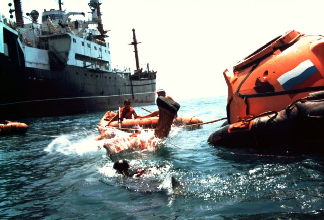 Astronaut Bill Shepherd, commander of the first International Space Station crew, plunges from a mockup Soyuz spacecraft descent module into the Black Sea recently during water survival training. Along with fellow crew members cosmonauts Yuri Gidzenko, Soyuz commander, and Sergei Krikalev, flight engineer, Shepherd will launch to the new station in January 1999 aboard a Soyuz spacecraft.