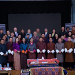 A group of people pose for a photo while at a conference.
