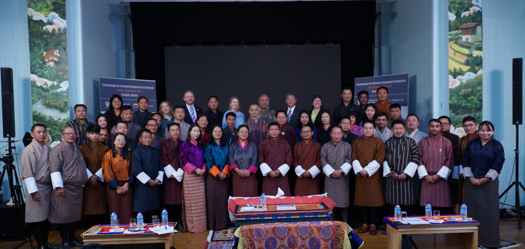 A group of people pose for a photo while at a conference.