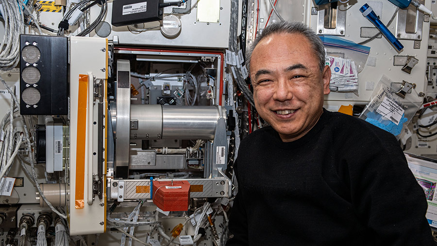Astronaut Satoshi Furukawa poses for a portrait next to cell biology research hardware inside the Kibo laboratory module.