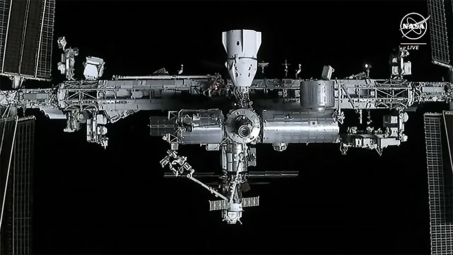 The station is viewed from the SpaceX Dragon cargo spacecraft. The SpaceX Dragon Endurance crew spacecraft is pictured at docked at center top. Credit: NASA TV