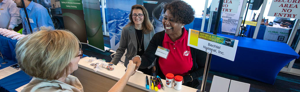Economic Development banner photo of two two individuals shaking hands at the 2019 NASA Business Opportunities Expo