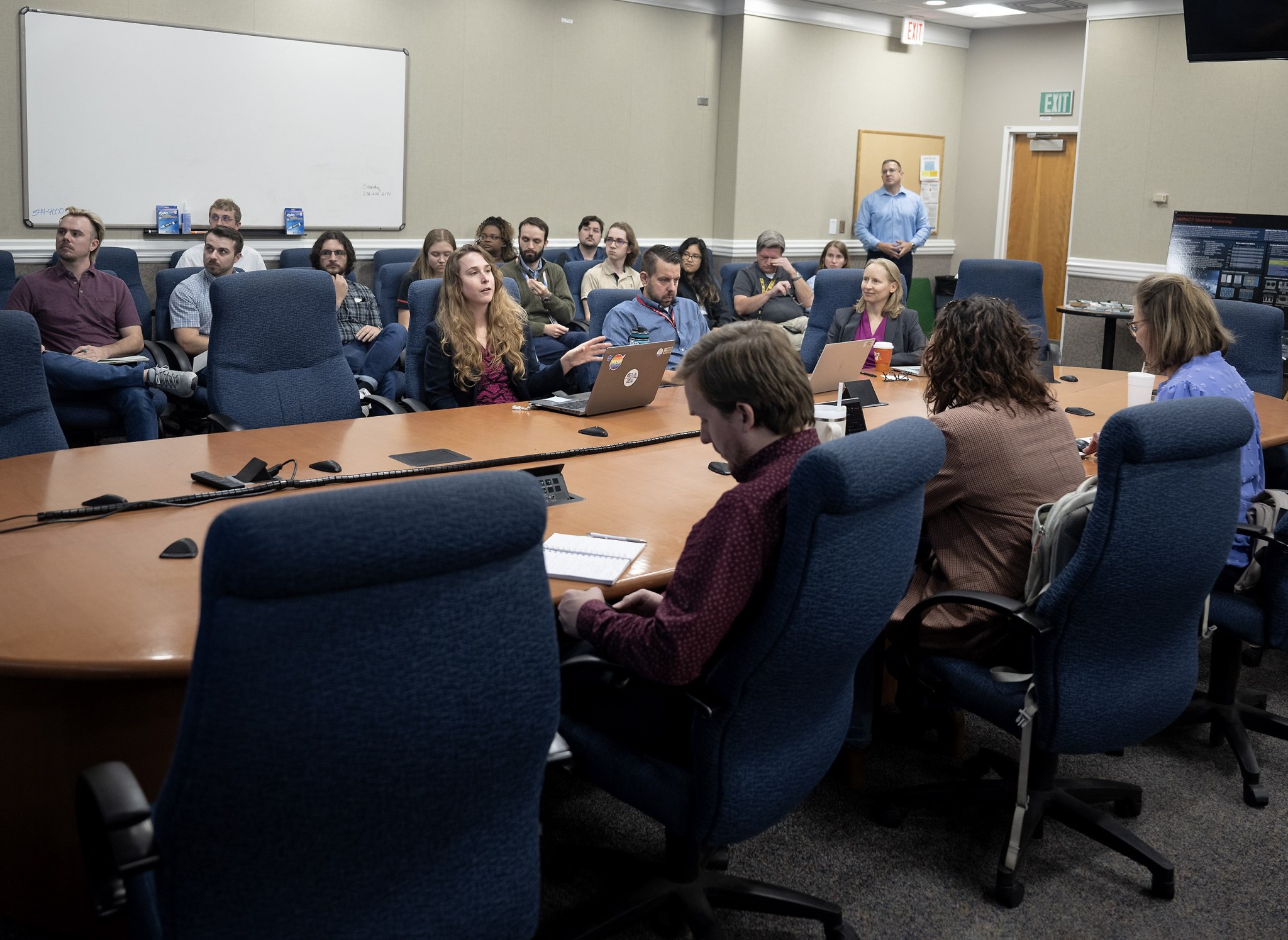 Materials test engineer Annette Gray, far left at table, explains how participants in Marshall’s MERCRII (Metallic Environmentally Resistant Coatings Rapid Innovation Initiative) worked with other centers and NASA partners to develop a radiation-resistant coating to improve the wear resistance of mechanism joints on the lunar or Martian surface.