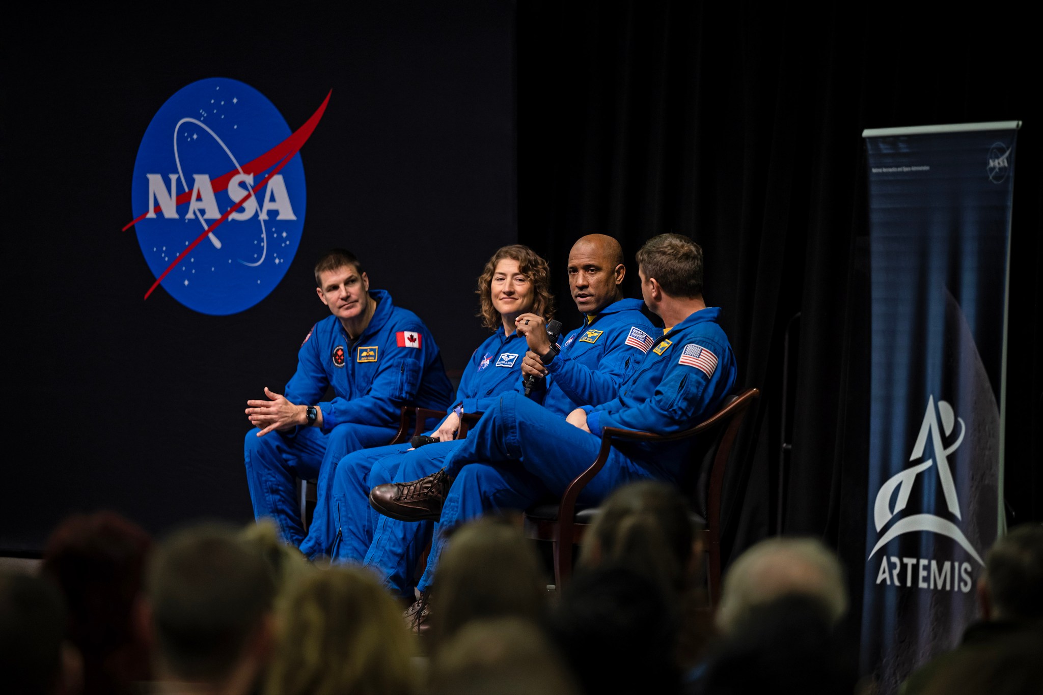 Glover, third from left, makes a point during the Artemis II crew event with Marshall team members.